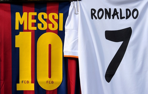 MADRID, SPAIN - MARCH 23:  Shirts bearing the names of Lionel Messi of FC Barcelona and Cristiano Ronaldo of Real Madrid CF are seen on display at a merchandise stall prior to the La Liga match between Real Madrid CF and FC Barcelona at estadio Santiago Bernabeu on March 23, 2014 in Madrid, Spain.  (Photo by Denis Doyle/Getty Images)